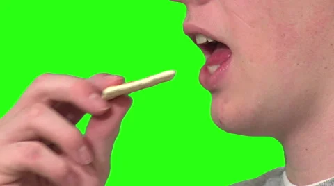 Eating a cracker, green background Stock Footage 49862510