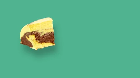 Eating cream cake on mint background. Looped stop motion animation. Creative Stock Footage 129563700