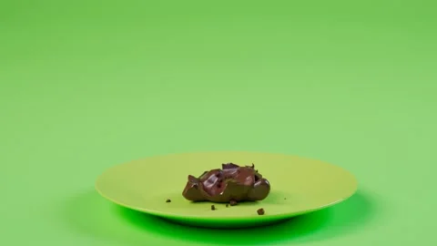 Eating a delicious chocolate Easter bunny. Cute rabbit on a green pastel plate Stock Footage 158247526