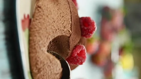 Eating delicious chocolate mousse with raspberry. Video stock 305154641