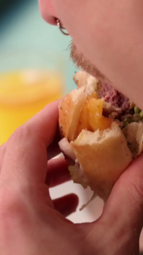 Eating a delicious hamburger Video stock 293473036