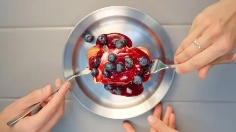 Eating Dessert with Raspberry Sauce and Blueberries from Above Stock Footage 343642012