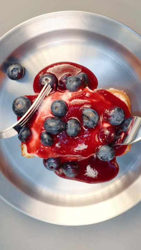 Eating Dessert with Raspberry Sauce and Blueberries Top View Stock Footage 343642053