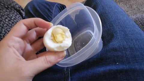 Eating Deviled Egg in Plastic Container 스톡 동영상 220367344