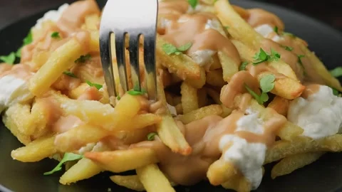 Eating with fork canadian dish poutine gravy and fries with cheese Video stock 292680093