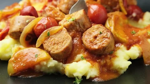 Eating with fork, Devilled Sausages with mashed potato, spiced tomato and apple Stock Footage 248285225