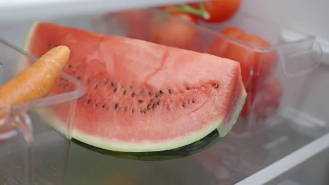 Eating fresh watermelon from the refrigerator Stock Footage 344890812