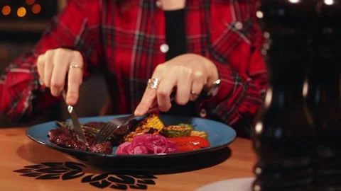 Eating fried meat with vegetables at the restaurant Stock Footage 144189727