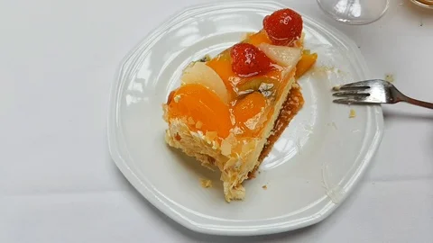 Eating fruit cake with a fork in a cafe Stock Footage 121836279