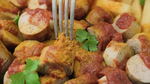 Eating German currywurst, served with chips and sauce. Stock Footage 251028225