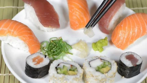 Eating ginger from a plate with sushi Stock Footage 73572706