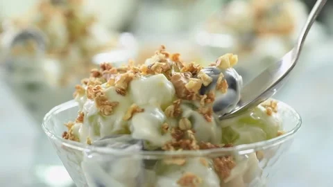 Eating of grape salad with yogurt. Stock Footage 170903094
