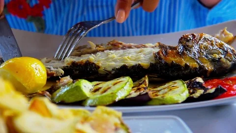 Eating grilled fish 스톡 동영상 76819247