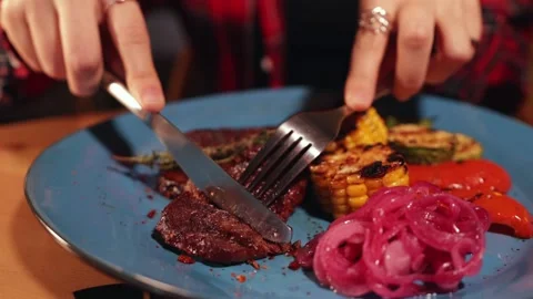 Eating grilled meat at the restaurant Stock Footage 144189643