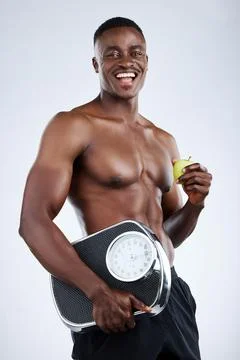 Eating healthy is the key to getting in shape. Studio portrait of a handsome Stock Photos