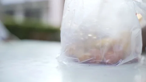 Eating hot food inside plastic bag Stock Footage 121104547