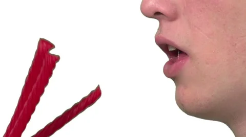 Eating licorice, white background Stock Footage 49862622