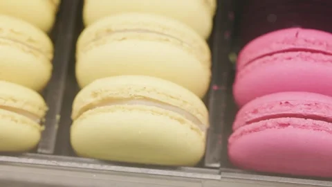 Eating macarons of different colors on a black plate Stock Footage 323324221