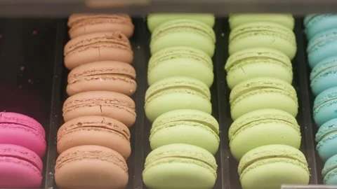 Eating macarons of different colors on a black plate Stock Footage 323328608