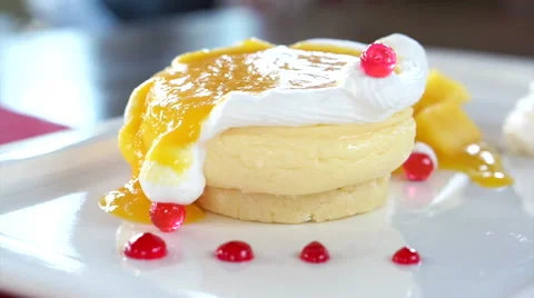 Eating Mango Cheese Cake on white plate with fresh fruit decoration Stock Footage 52849594