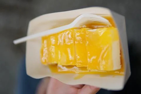 Eating a mango cheesecake Foto stock