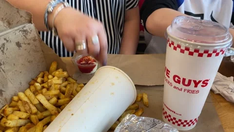 Eating a meal at Five Guys Stock Footage 174336654