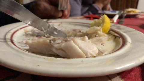 Eating mullet fish on the plate Stock Footage 122045206