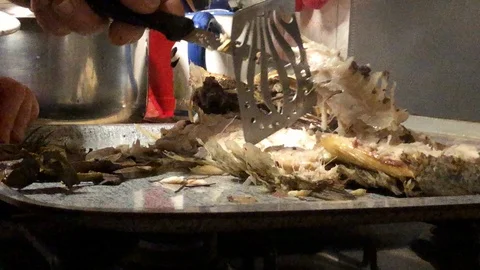 Eating mullet fish on the plate Stock Footage 122074639