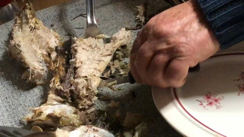 Eating mullet fish on the plate Stock Footage 122077849