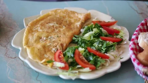 Eating an omelette with salad and bread in a café Stock Footage 334093372