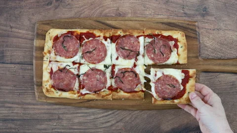 Eating a Pepperoni Flatbread Pizza Stock Footage 162736550