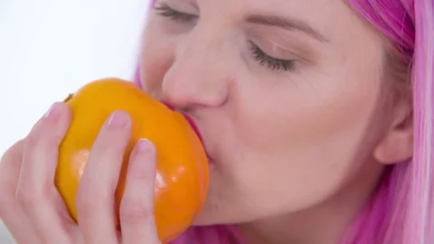 Eating the persimmon fruit Stock Footage 83726254