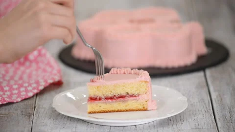 Eating a piece of raspberry cake with pink cream. Stock Footage 121194431