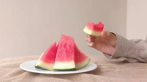 Eating a piece of a small watermelon Stock Footage 146256532