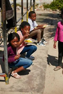 Eating on the playground. Full length portrait of children getting fed at a food Stock Photos