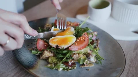 Eating a poached egg Stock Footage 164381217