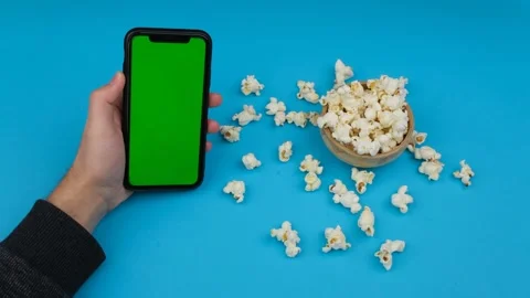 Eating popcorn with smart phone Stock Footage 260163426