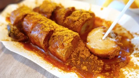 Eating popular German currywurst sausage Close up Shallow DOF Stock Footage