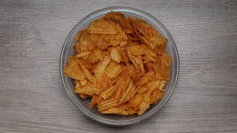 Eating Potato CHIPS - Time Lapse, top view video. Last crumble is emphasized. Stockbeeldmateriaal 107208919