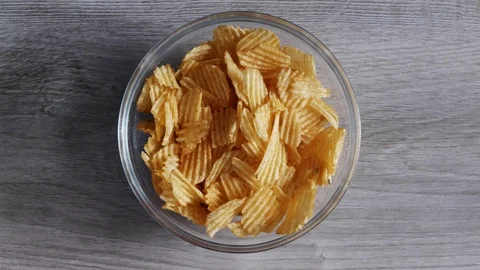 Eating Potato CHIPS - Time Lapse, top view video. Last crumble is emphasized. Stock Footage 107208941