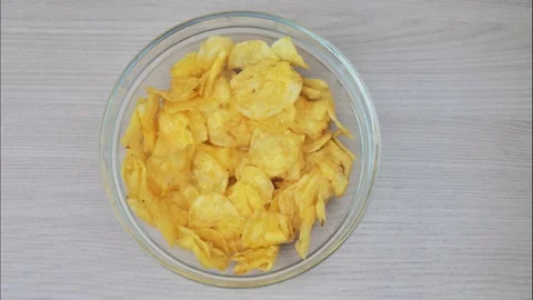 Eating Potato CHIPS - Time Lapse, top view video. Last crumble is emphasized. Video stock 221945038