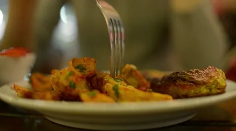 Eating potato with fork Stock Footage 56620625