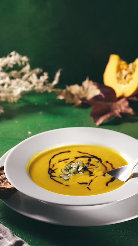 Eating pumpkin soup with spoon Stock Footage 247707368