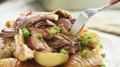 Eating roasted lamb shoulder with vegetables. Stock Footage 195531271