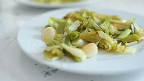 Eating roasted leek Stock Footage 321228343