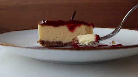 Eating a Slice of Berry Cheesecake Stock Footage 185591538