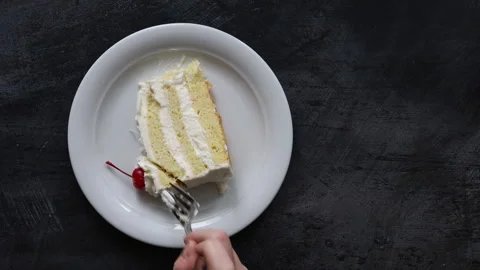 Eating a Slice of Coconut Cake with Space for Copy Stock Footage 296169319