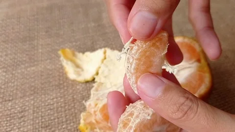 Eating a slice of sweet orange fruit Stock Footage 150523056