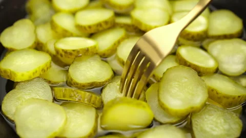 Eating sliced Pickled cucumbers with fork, close up Stock Footage 235457307
