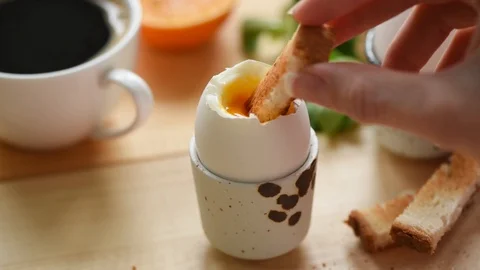 Eating soft boiled egg with toasted bread Stock Footage 106755384
